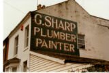 Ghost sign for G. Sharp plumber and painter, Melton Road, Syston, taken in 1996.